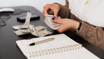 person counting money to borrow vs lend