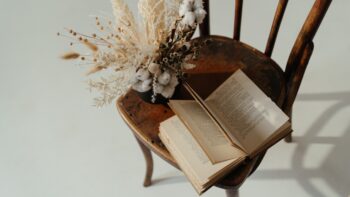 Book idioms - a book on a chair with dry flowers next to it