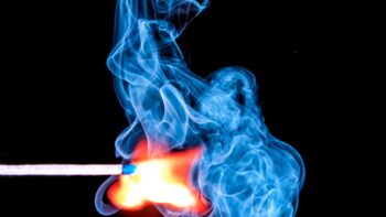 Idioms about smoke - a close up of a match igniting
