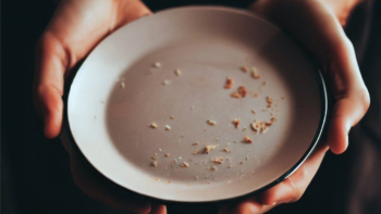 someone holding a plate and wondering is there anymore vs any more food to eat