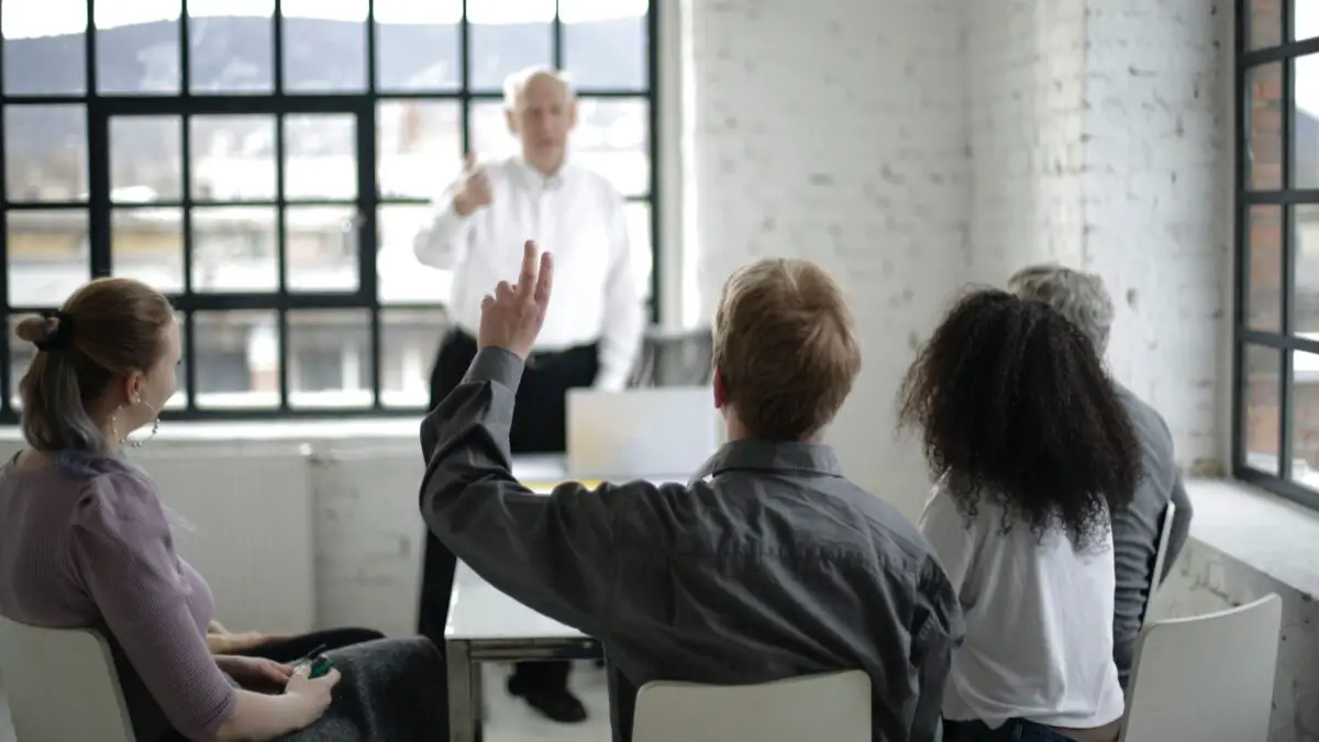 man asking embedded indirect questions in a meeting