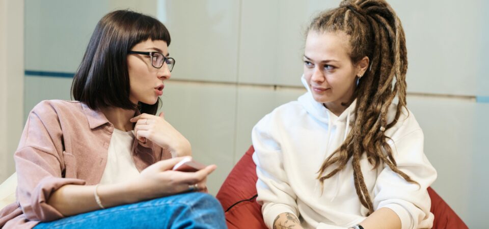 friends discussing how to learn to speak english at home