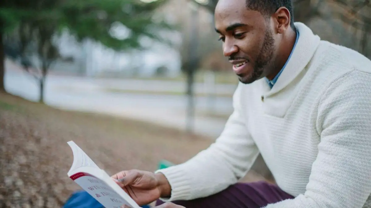 man reading a book to learn English reading