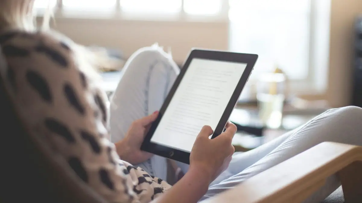 woman learning english by reading an ebook